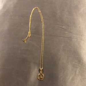 Gold necklace with peace sign